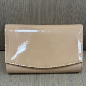 Elegant, shiny clutch purse with attached chain strap